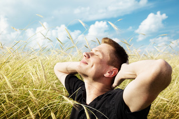 young man rest on wheat field