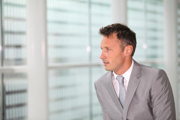 Fototapeta premium Portrait of businessman in grey suit