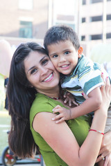 Happy womanr embracing toddler child