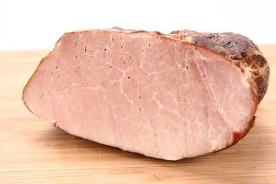 Piece of ham on a wooden board