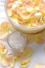 beauty treatment- bowl of pink bath salt with pink rose petals -
