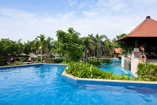 Open air swimming pool in the tropical garden.