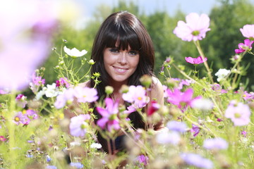 Obraz na płótnie Canvas jeune femme dans un champs de fleurs