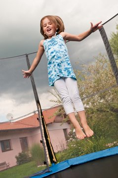 Big fun - child jumping trampoline