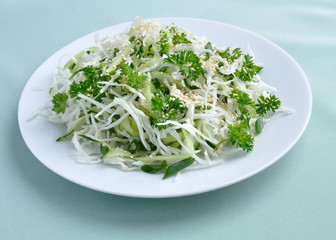 Salad of fresh cabbage and cucumber with herbs and sesame
