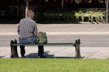 A man waiting on a bench