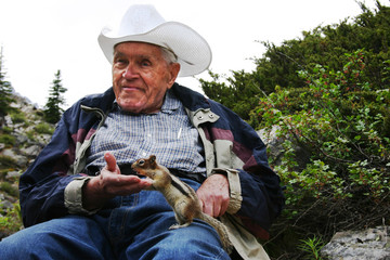 Naklejka na ściany i meble Elderly man with chipmunk