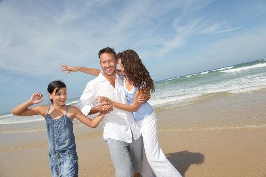 Family walking by the beach in summer