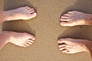 feet of a couple at the beach