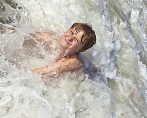 child has fun in the waves