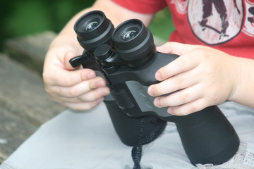 binoculars in boy's arms