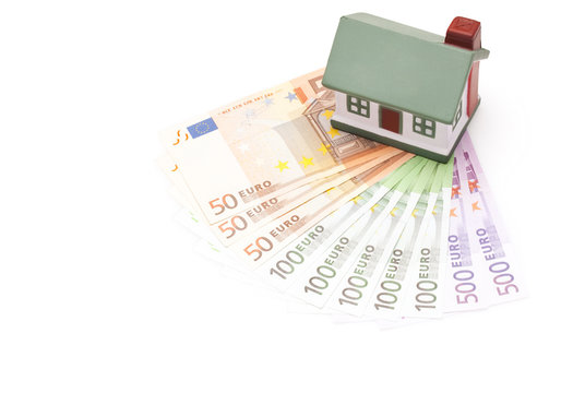 toy house on top of european banknotes