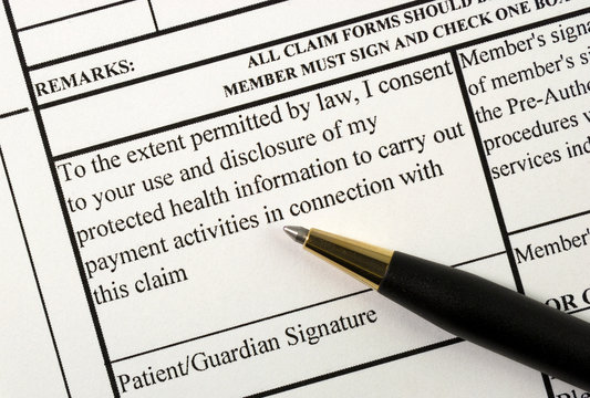A patient signs the medical claim form