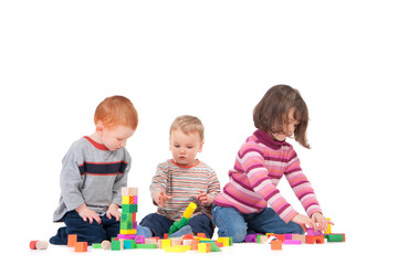 Preschoolers playing with wooden blocks