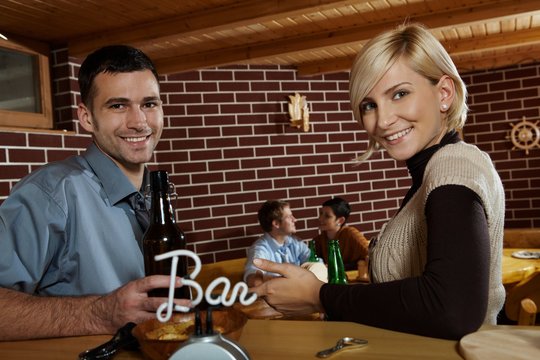 Portrait of young couple in bar