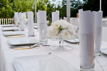 Wedding table with rose in glass