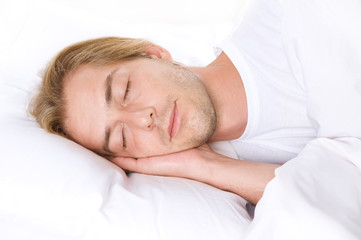 Young Man Sleeping on the white Bed