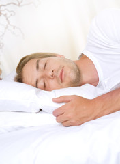 Fototapeta na wymiar Young Man Sleeping in his Bed