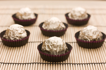 Choco  candies in golden foil on table