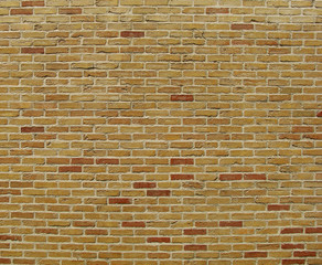 yellow orange red colored bricks in a large wall