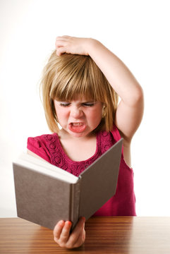 child frustrated with book