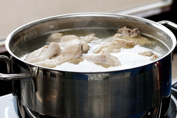 Homemade chicken bouillon in a pot