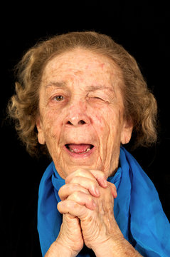 Up-close Face Of Wrinkled Elderly Women Winking