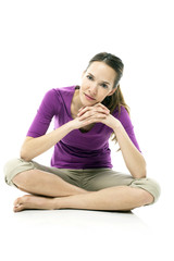 Young woman sitting on the floor on white background studio