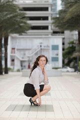 Businesswoman squatting
