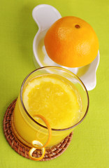 Fresh orange juice in glass and squeezer (Selective Focus)