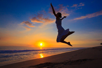 Young girl jumping in the sunset