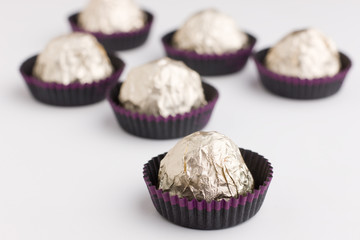 Choco  candies in golden foil on table