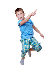 Young boy jumping over white background