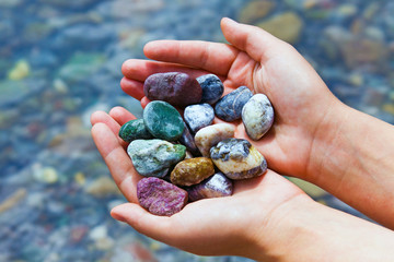 COLORFUL STONES IN HANDS