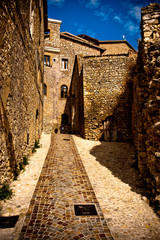 romantic old italian stone building with stone path and blue sky