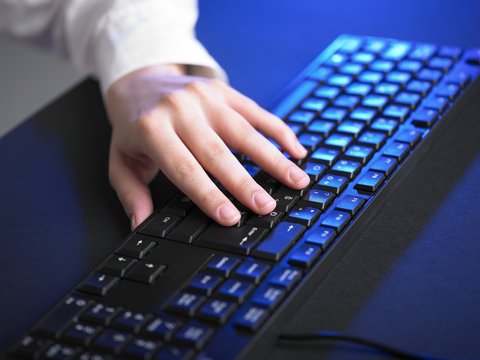 Hand typing on keyboard