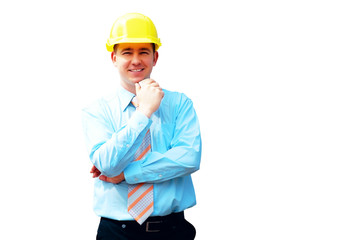 Young architect wearing a protective helmet standing on the buil
