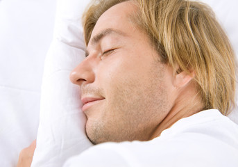 Fototapeta na wymiar Handsome Man Sleeping in his Bed