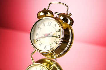 Time concept - alarm clock against colorful background