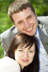 just married in a flowering garden sitting on the grass