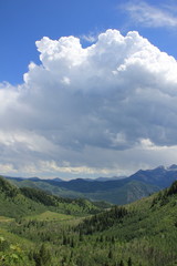 Naklejka premium Mountain valley with storm moving in