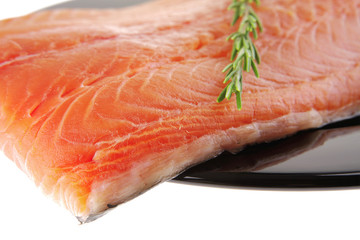fresh raw salmon fillet on black with rosemary