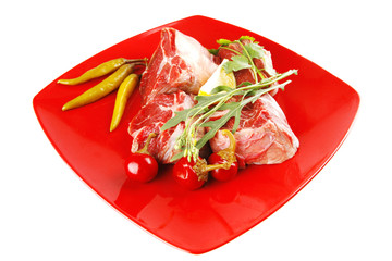 raw beef medallion on red