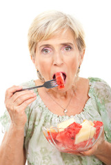 Beauty senior woman eating watermelon