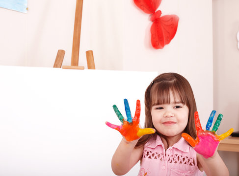 Child  making hand prints.