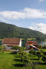 Fototapeta na wymiar Cottages beside Sognefjord at Balestrand