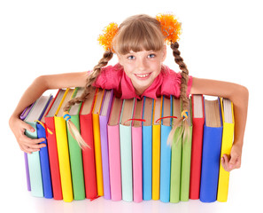 Child reading open  book on table.