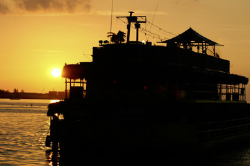 sunset behind boat