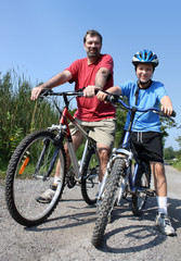 Fototapeta premium father and son biking