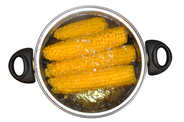 Corn in a saucepan, in boiling water